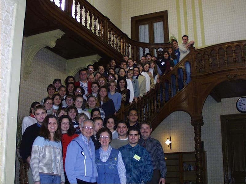 Dr. Zuck and his wife with a large group on a staircase